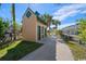 Exterior view of beach restrooms on a paved walkway surrounded by palm trees at 9661 Shore Dr. # B-3, Myrtle Beach, SC 29572