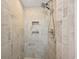 Modern shower with neutral tiles, recessed shelving, and a rainfall shower head at 9661 Shore Dr. # B-3, Myrtle Beach, SC 29572