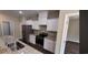 Stylish kitchen with stainless steel appliances and bright white cabinets at Tbd 81 Persimmon Rd., Aynor, SC 29511