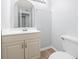 Bathroom featuring light beige vanity, mirror, light fixture, and toilet with neutral flooring at 1100 Possum Trot Rd. # B102, North Myrtle Beach, SC 29582