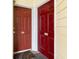Close-up of two red entry doors, numbered 102 and 103, indicating separate units in the building at 1100 Possum Trot Rd. # B102, North Myrtle Beach, SC 29582