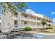 Charming condo building with multiple floors, exterior corridors, and manicured landscaping under a blue sky at 1100 Possum Trot Rd. # B102, North Myrtle Beach, SC 29582