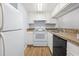 Well-lit kitchen with white cabinets and modern appliances, creating a clean and functional space at 1100 Possum Trot Rd. # B102, North Myrtle Beach, SC 29582