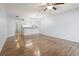 Open concept living room with ceiling fan, breakfast bar, and hardwood floors at 1100 Possum Trot Rd. # B102, North Myrtle Beach, SC 29582