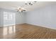 Spacious living room features beautiful hardwood floors and ample natural light with open view to other room at 1100 Possum Trot Rd. # B102, North Myrtle Beach, SC 29582