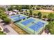 Aerial view of multiple community tennis courts with lighting, benches and parking at 1100 Possum Trot Rd. # B102, North Myrtle Beach, SC 29582