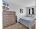 Cozy bedroom featuring a dresser, a TV, and a comfortable bed with blue bedding at 1100 Possum Trot Rd. # D-205, North Myrtle Beach, SC 29582