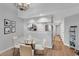Dining area with hardwood floors, a glass table, and view into the well-equipped kitchen at 1100 Possum Trot Rd. # D-205, North Myrtle Beach, SC 29582