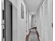 Hallway with hardwood floors, a rug, and paneled closet doors at 1100 Possum Trot Rd. # D-205, North Myrtle Beach, SC 29582
