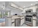 Bright kitchen with stainless steel appliances, counter seating, and sliding door access to a patio at 1100 Possum Trot Rd. # D-205, North Myrtle Beach, SC 29582