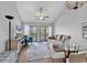 Cozy living room showcasing a glass dining table, comfortable seating, and access to the balcony at 1100 Possum Trot Rd. # D-205, North Myrtle Beach, SC 29582