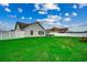 Expansive backyard with white fencing, green lawn, and patio area at 113 Camrose Way, Myrtle Beach, SC 29588