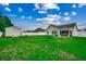 Large backyard with a well-maintained lawn, white fence, and patio area at 113 Camrose Way, Myrtle Beach, SC 29588
