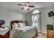 Bedroom with ceiling fan, arched window and decor at 113 Camrose Way, Myrtle Beach, SC 29588