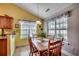 Inviting breakfast nook featuring a wood dining table, sun-filled windows, and cheerful decor at 113 Camrose Way, Myrtle Beach, SC 29588