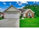 Charming single-story home featuring a two-car garage, manicured lawn, and lovely brick accents at 113 Camrose Way, Myrtle Beach, SC 29588