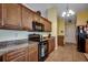 A bright kitchen features granite countertops and wooden cabinetry at 113 Camrose Way, Myrtle Beach, SC 29588