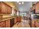 Kitchen featuring wood cabinets, granite counters, and a view to the dining area at 113 Camrose Way, Myrtle Beach, SC 29588