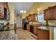 Charming kitchen features granite counters, tile flooring, and stainless steel appliances at 113 Camrose Way, Myrtle Beach, SC 29588