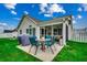 Screened-in patio with dining set and outdoor furniture overlooking the backyard at 113 Camrose Way, Myrtle Beach, SC 29588