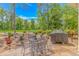 Outdoor patio space with seating and a grill, surrounded by lush landscaping at 1206 Spinnaker Dr., North Myrtle Beach, SC 29582