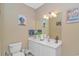 Well-lit bathroom featuring a modern vanity and artistic decor at 1206 Spinnaker Dr., North Myrtle Beach, SC 29582