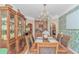 Elegant dining room with a chandelier, custom hutch, and easy access to a serving area at 1206 Spinnaker Dr., North Myrtle Beach, SC 29582