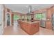 Modern kitchen with large island, stainless appliances, ample cabinets, and tile floors at 1206 Spinnaker Dr., North Myrtle Beach, SC 29582