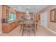 Open kitchen with a large island, stainless steel appliances, tile floors, and plenty of natural light at 1206 Spinnaker Dr., North Myrtle Beach, SC 29582