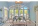 Comfortable living room with light blue walls and large windows overlooking the lush yard at 1206 Spinnaker Dr., North Myrtle Beach, SC 29582