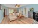 Bright living room featuring a comfortable sectional, hardwood floors, and natural light at 1206 Spinnaker Dr., North Myrtle Beach, SC 29582
