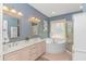 Main bathroom features a soaking tub, double sinks, and a separate glass shower at 1206 Spinnaker Dr., North Myrtle Beach, SC 29582