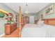 Bright main bedroom boasts a four-poster bed, a chandelier, and wood floors at 1206 Spinnaker Dr., North Myrtle Beach, SC 29582