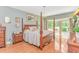 Spacious main bedroom with four-poster bed, chandelier, and sliding doors to the outside at 1206 Spinnaker Dr., North Myrtle Beach, SC 29582