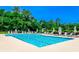 Large outdoor pool with lounge chairs and umbrellas on a sunny day at 1206 Spinnaker Dr., North Myrtle Beach, SC 29582