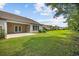 Well-maintained backyard with green grass, trees, and covered patio of home at 122 Parmelee Dr. # A, Murrells Inlet, SC 29576