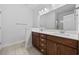 Bathroom featuring dual sinks, wood cabinets and a large mirror at 122 Parmelee Dr. # A, Murrells Inlet, SC 29576
