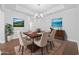 Formal dining room with tray ceiling, chandelier, and furniture arranged on an patterned area rug at 122 Parmelee Dr. # A, Murrells Inlet, SC 29576