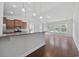 Open-concept living area featuring hardwood floors and views of the kitchen and backyard at 122 Parmelee Dr. # A, Murrells Inlet, SC 29576