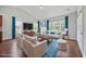 Bright living room with large windows, wood floors, and stylish furniture at 122 Parmelee Dr. # A, Murrells Inlet, SC 29576