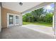 Covered patio with concrete flooring overlooking the green backyard and trees at 122 Parmelee Dr. # A, Murrells Inlet, SC 29576