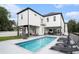 Rear exterior view featuring a pool, covered outdoor living space, backyard, and a home balcony at 1279 Fiddlehead Way, Myrtle Beach, SC 29579