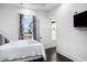 Cozy bedroom with a large window, plush bed, and view to the outside at 1279 Fiddlehead Way, Myrtle Beach, SC 29579