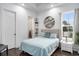Bedroom with ample natural light, stylish decor, and view of the outside at 1279 Fiddlehead Way, Myrtle Beach, SC 29579