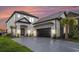 Stunning two-story home featuring a modern design, a two-car garage, and lush landscaping at 1279 Fiddlehead Way, Myrtle Beach, SC 29579