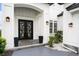 Close-up of the home's modern front entrance with a beautiful door and manicured landscaping at 1279 Fiddlehead Way, Myrtle Beach, SC 29579