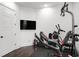 Spacious gym area featuring a large television, gym equipment, and hardwood floors at 1279 Fiddlehead Way, Myrtle Beach, SC 29579