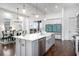 Bright, open kitchen features a large island, stainless steel appliances, and a view of the dining area at 1279 Fiddlehead Way, Myrtle Beach, SC 29579