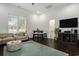 Spacious living room with modern furniture, hardwood floors, and a large television at 1279 Fiddlehead Way, Myrtle Beach, SC 29579