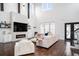Spacious living room featuring a fireplace, high ceilings, and large windows with natural light at 1279 Fiddlehead Way, Myrtle Beach, SC 29579